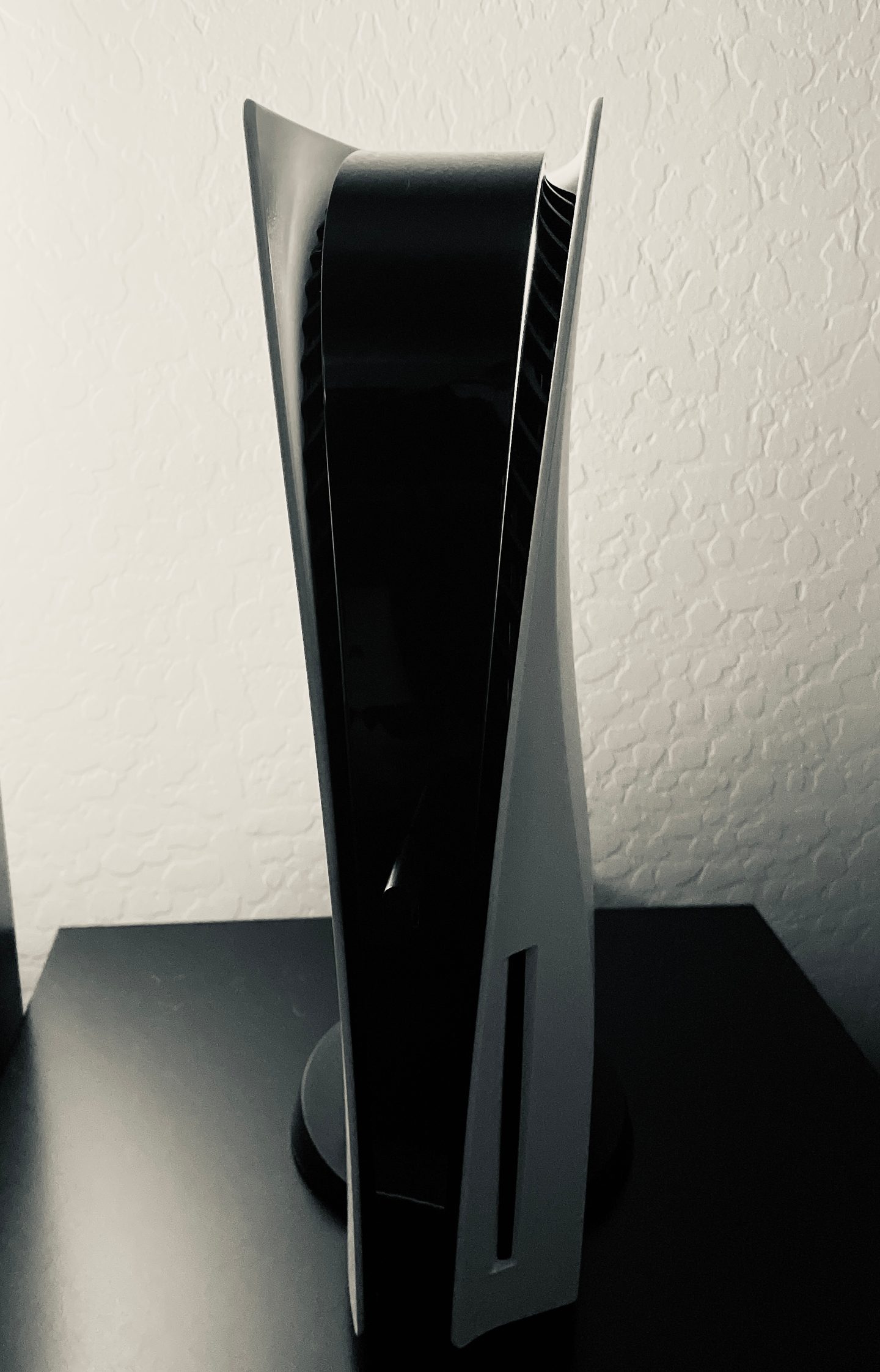 A PlayStation 5 console standing upright